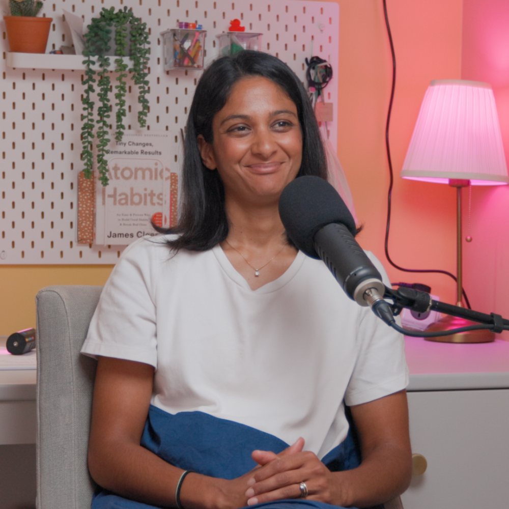 Anisha smiling at the mic in the studio